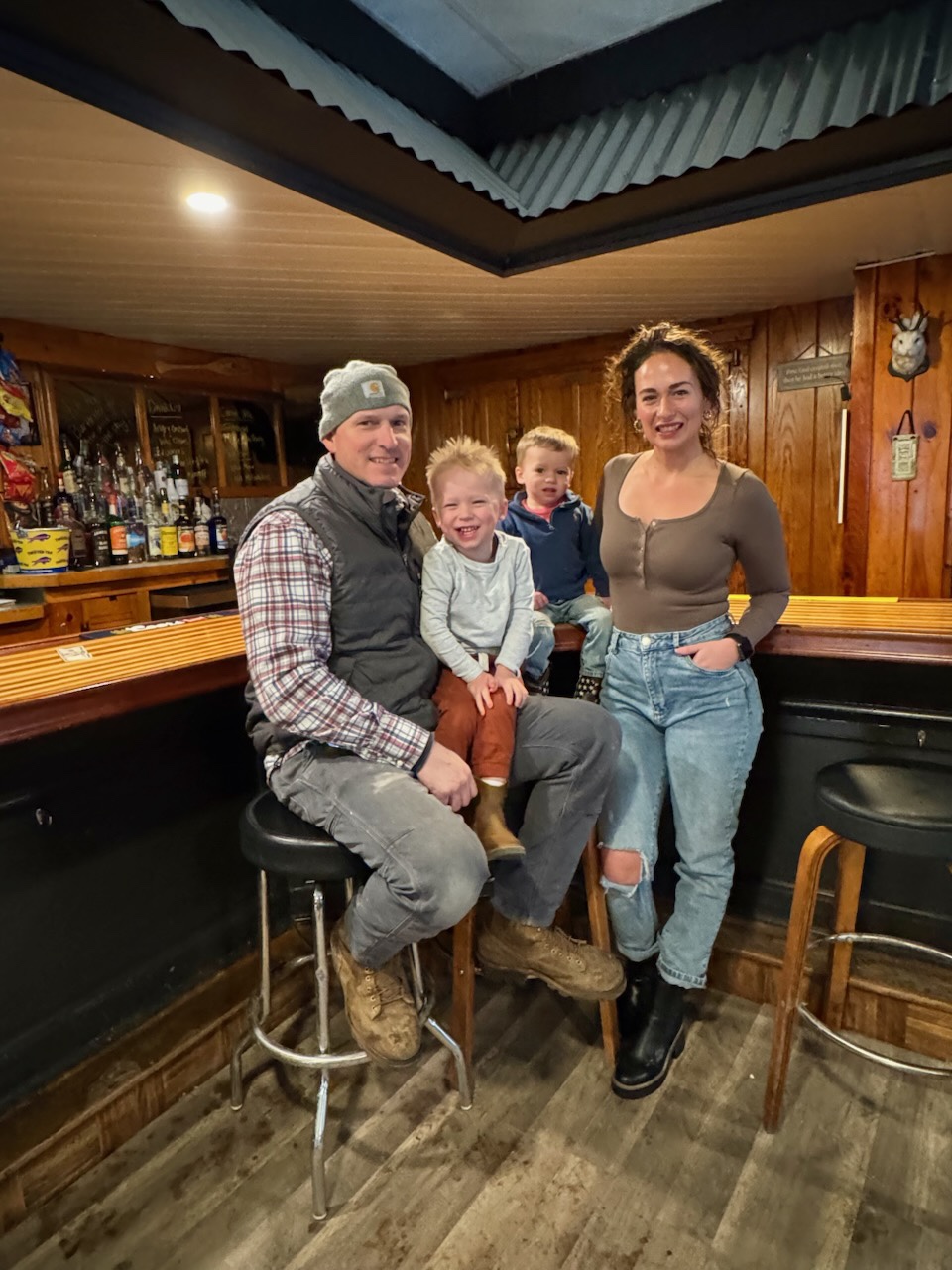 Erik and Jen Kelly with their two sons inside the Backdoor Bar and Grille